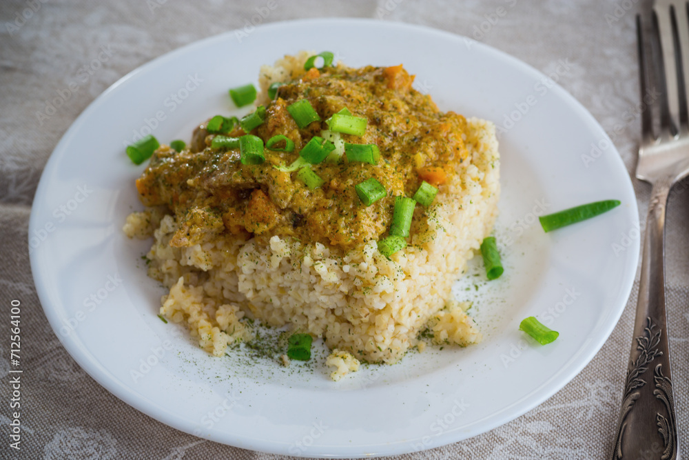 cooked bulgur with meat sauce and vegetables in a plate cooked bulgur with meat sauce and vegetables in a plate