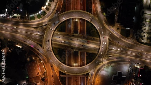 Aerial drone night cinematic video of illuminated urban elevated toll ring road junction and interchange overpass passing through Kifisias Avenue, Attica, Greece photo