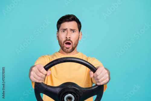 Closeup photo of young funny confused sad man driving automobile after examination forgot turn side isolated on blue color background
