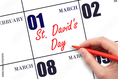 March 1. Hand writing text St. David's Day on calendar date. Save the date. photo