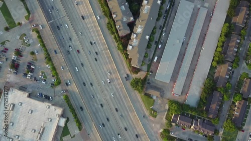 top view crossing traffic freeway road 75 with cars and neighborhood houses by sunset USA