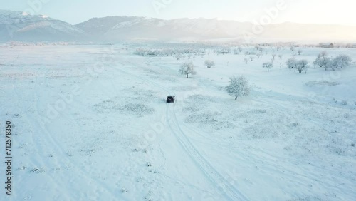 Winter mountain snow field, car drive on snow country road
