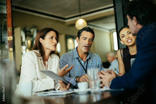 Diverse business people talking in cafe or bar photo