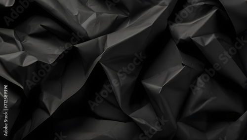Black crumpled paper texture abstract background