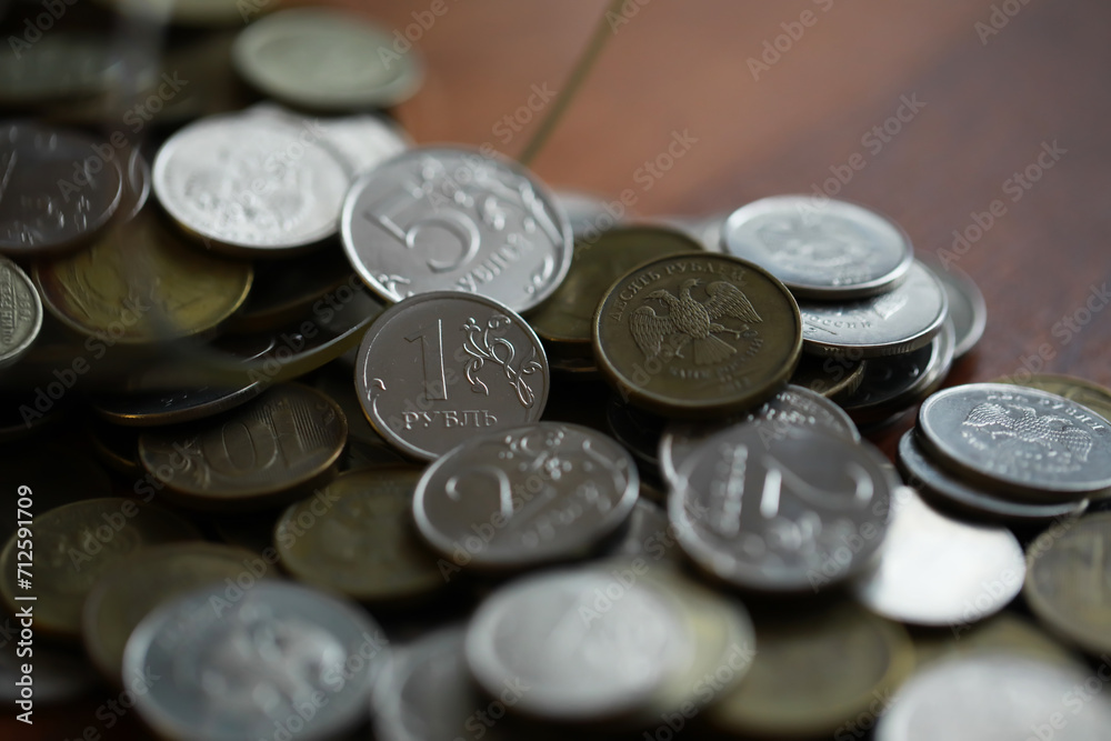 Russian rubles and metal coins inside a glass jar close-up on black blurred background Russian rubles and metal coins inside a glass jar close-up on black blurred background
