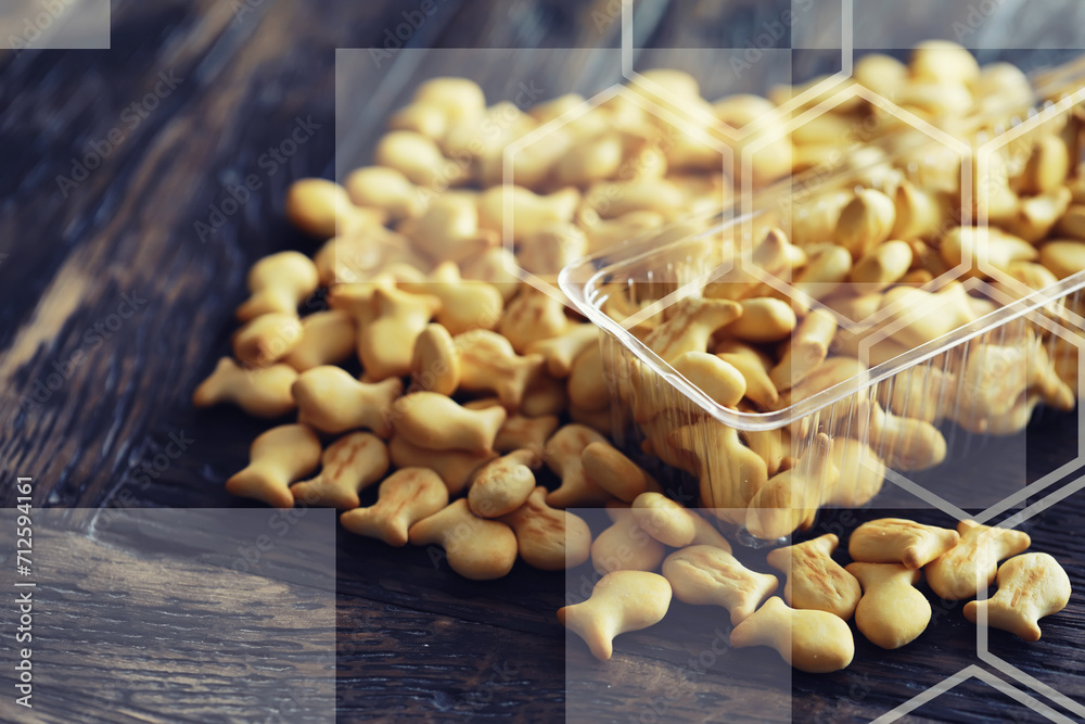 Closeup view of fish shaped salted crackers. Small tasty biscuits. Fish shaped cookies background.