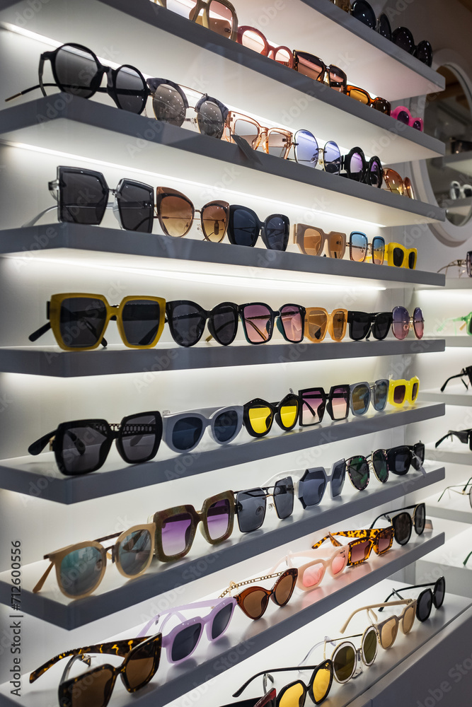 Display rack full of sunglasses. Fashionable sunglasses on the shop shelf