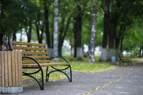 Autumnal park with bench. Falling leaves. Focus on bench © alexkich
