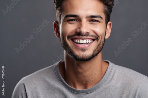 Close Up man Beautiful smile on grey background. Teeth whitening photo