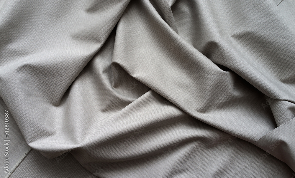 Top view of gray textile background with large creases. Stylish suiting fabric with textured pattern made from natural fibers. Flat lay, close-up, copy space, mockup Top view of gray textile background with large creases. Stylish suiting fabric with textured pattern made from natural fibers. Flat lay, close-up, copy space, mockup