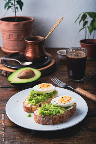 Toasts with mashed avocado, cream cheese and boiled egg