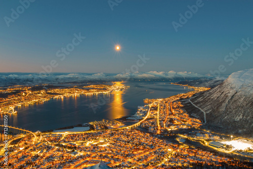 Norway- Troms og Finnmark- Tromso- long exposure of illuminated city seen from Fjellheisen at sunset