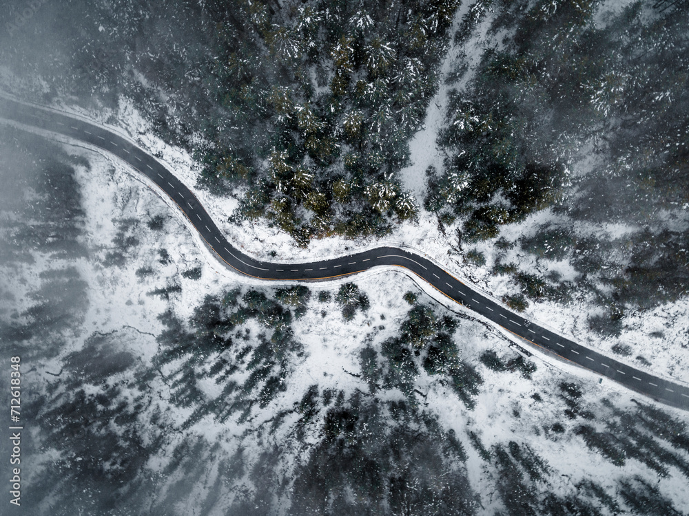 Snow forest areial view with road