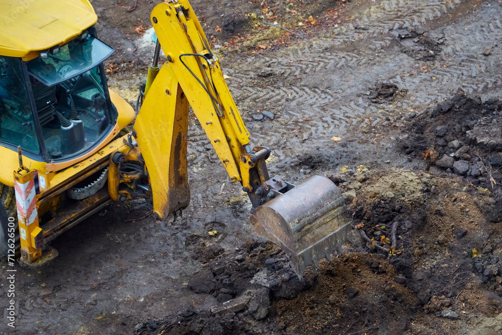 Excavator at earthworks, operating construction equipment Excavator at earthworks, operating construction equipment