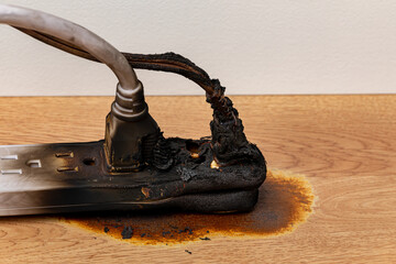 Electrical surge protector outlet and extension cord fire. Electricity safety, fire hazard and circuit overload concept.