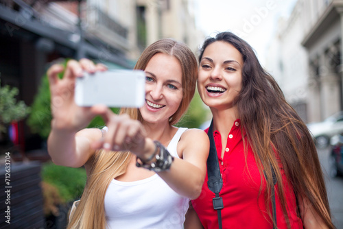 Close up lifestyle portrait of girls best friends makes funny grimaces on camera