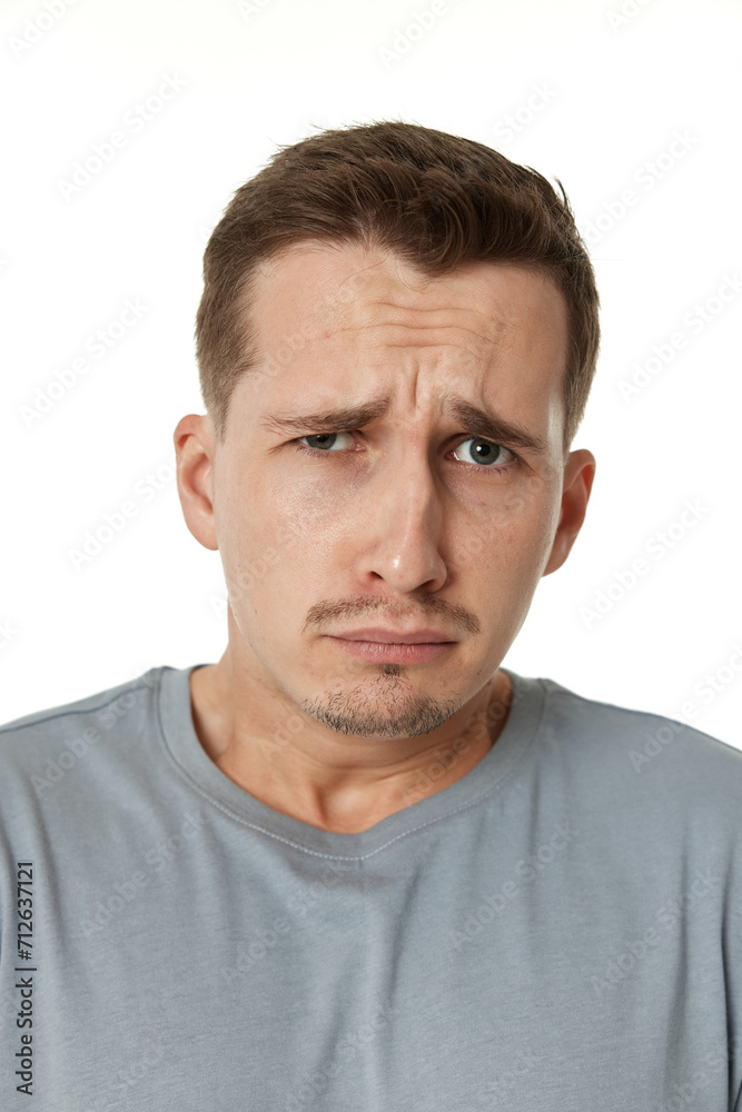 offended frustrated young man on white background. sadness offended frustrated young man on white background. sadness