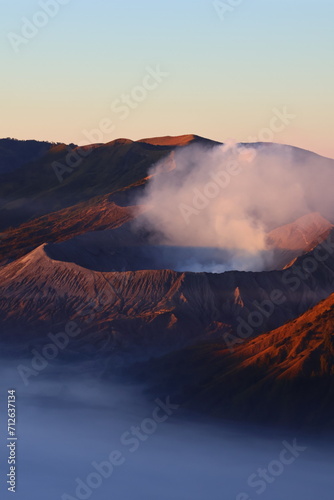 Scenic view of Mount Bromo in the morning with red shiny sunlight during sunrise.
