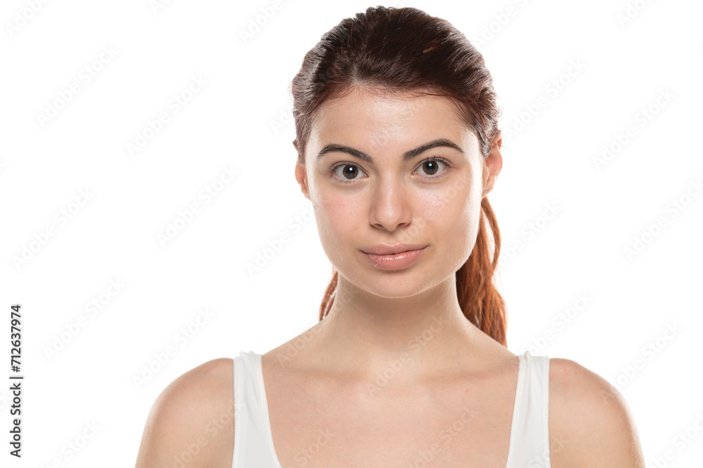 a young woman without makeup with long red hair on a white studio background a young woman without makeup with long red hair on a white studio background