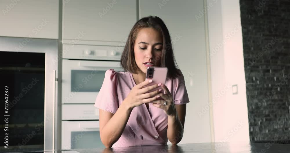 Young upset woman receive sms, read bad news in message, staring at device screen looks dissatisfied, feels irritated due to awful information in notice. Mobile app crash, failure, personal concerns Young upset woman receive sms, read bad news in message, staring at device screen looks dissatisfied, feels irritated due to awful information in notice. Mobile app crash, failure, personal concerns