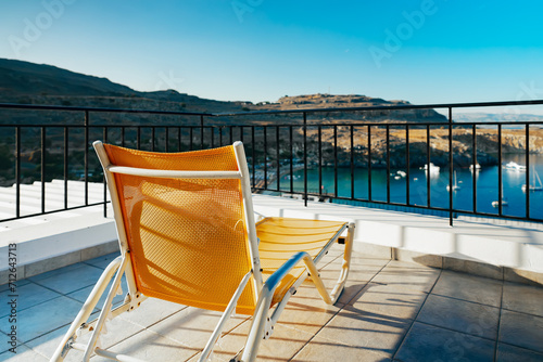 Sun lounger on the roof of a house with a wonderful view. Concept of rest.