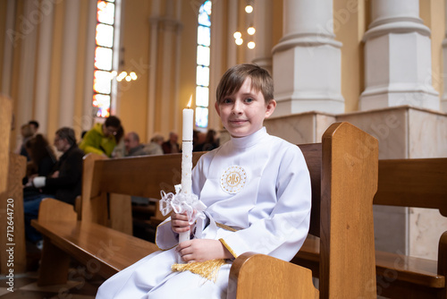 boy before first Eucharist in a catholic church. child in white clothes in the church