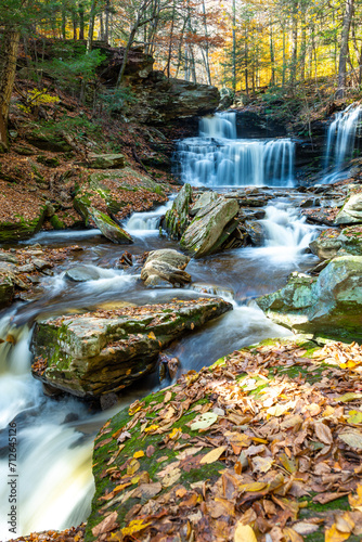 Cascade of waterfalls in a mountain gorge, fast flowing water, long exposure