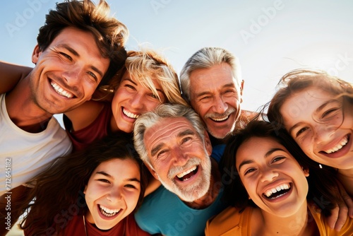A joyful multigenerational family with beaming smiles enjoys a sunny day together outdoors, sharing love and happiness.
