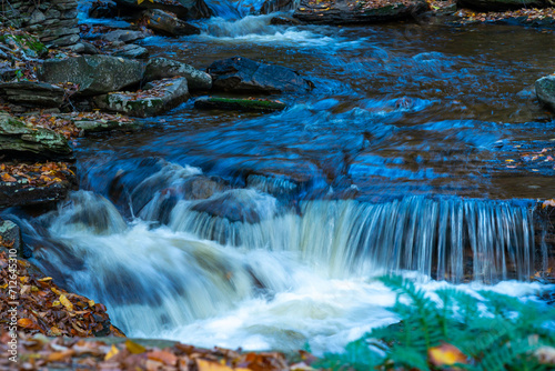 Cascade of waterfalls in a mountain gorge  fast flowing water  long exposure