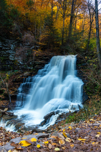 Cascade of waterfalls in a mountain gorge  fast flowing water  long exposure