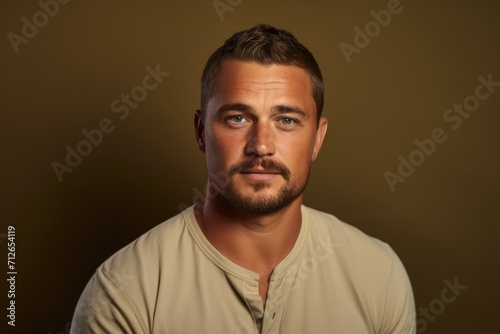 Portrait of a handsome young man posing over dark background. Men's beauty, fashion.