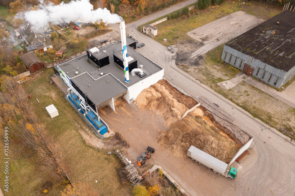 Drone photography of biomass power plant and biomass storage place during autumn day Drone photography of biomass power plant and biomass storage place during autumn day