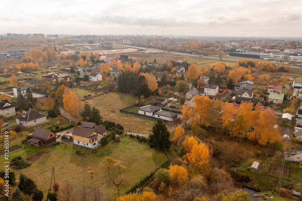 Drone photography of city suburbs landscape with low density houses during autumn day