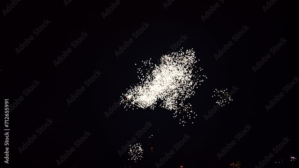 Fireworks exploding in various colors in the dark night sky during a celebration. 4K clip suitable as background.