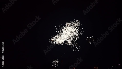 Fireworks exploding in various colors in the dark night sky during a celebration. 4K clip suitable as background. photo