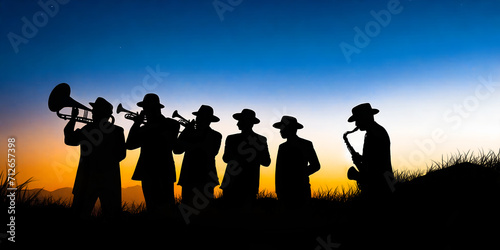 Photography Silhouette of a group of musicians playing jazz in the middle of a meadow in the evening sun with mountains in background