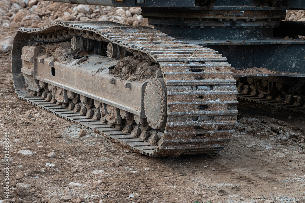 Excavator wheels on mud, dirty machine detail on mud. Excavator wheels on mud, dirty machine detail on mud.
