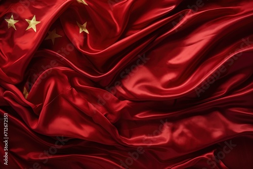 Red Chinese flag made of silk with golden stars photo