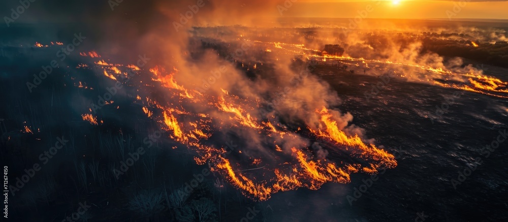 Aerial view of nature ablaze with wildfire during the dry season.