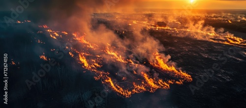 Aerial view of nature ablaze with wildfire during the dry season.