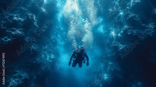 Diver with diving suit, diving in a coral reef with many jellyfish and fish © Nico