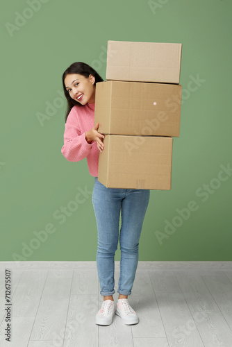 Pretty young woman carrying...