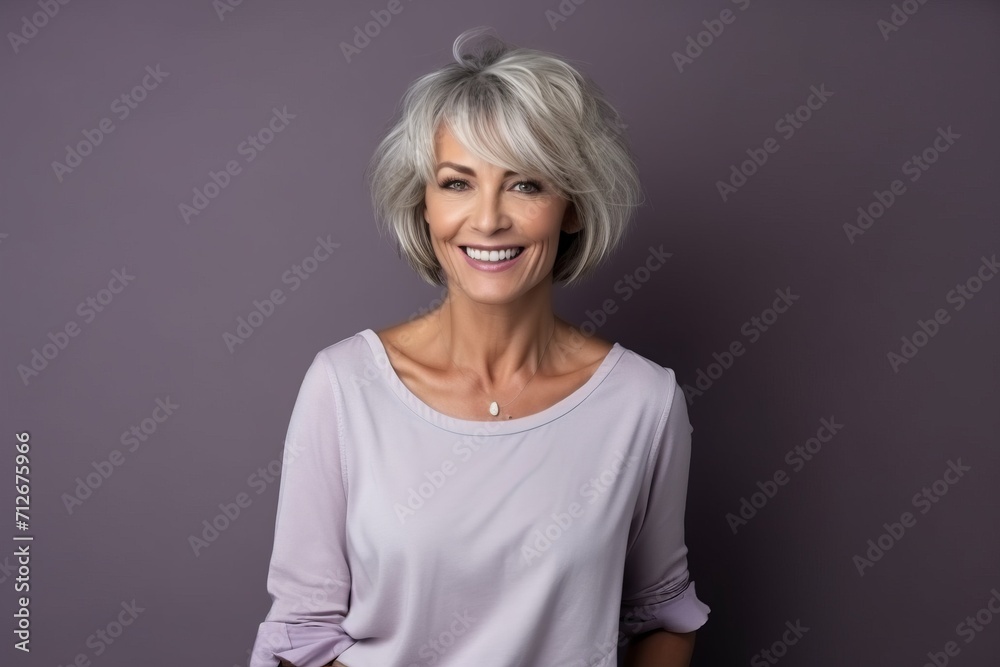 Portrait of a beautiful senior woman with grey hair smiling at the camera