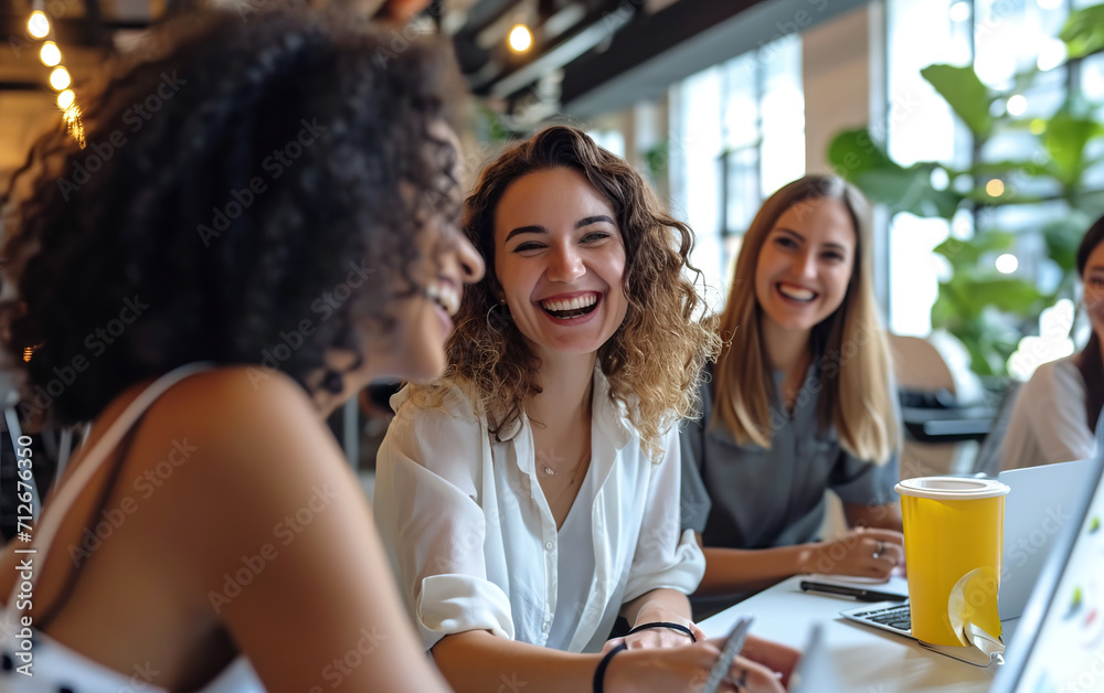 Cheerful businesswomen collaborate in a modern office