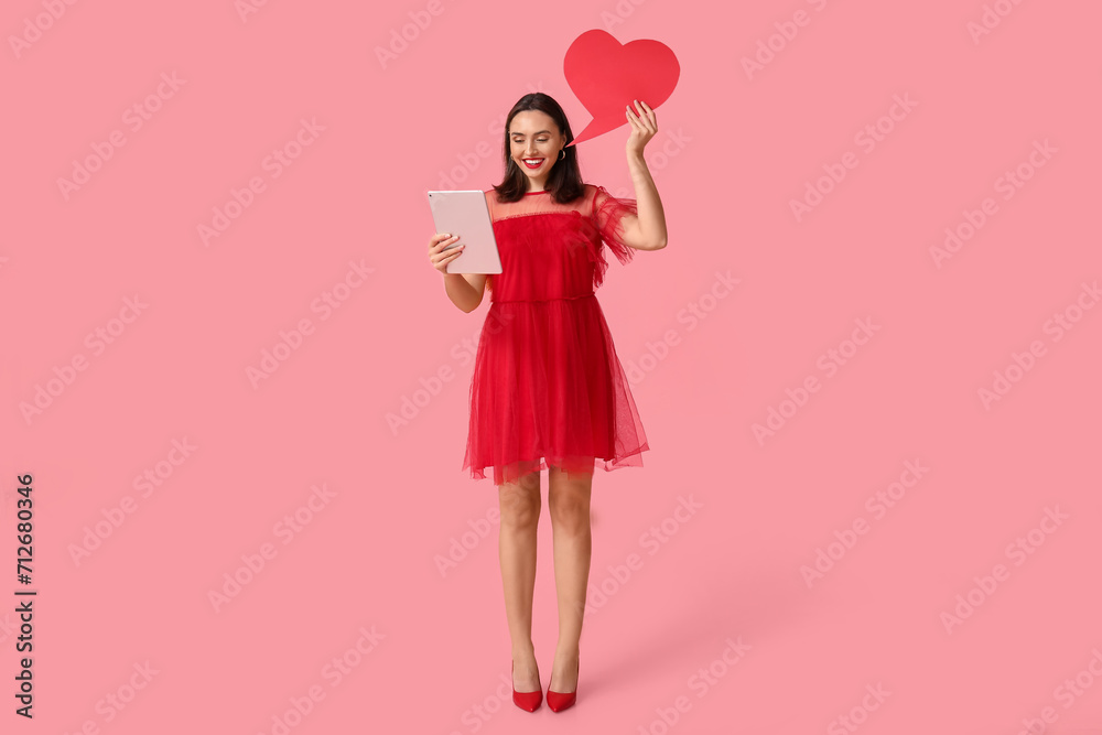Young woman with tablet computer and speech bubble on pink background. Online dating Young woman with tablet computer and speech bubble on pink background. Online dating