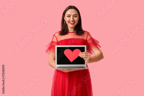 Happy young woman with lapt...