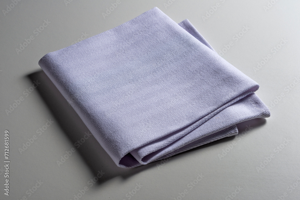 Perspective view of folded light blue napkin Perspective view of folded light blue napkin