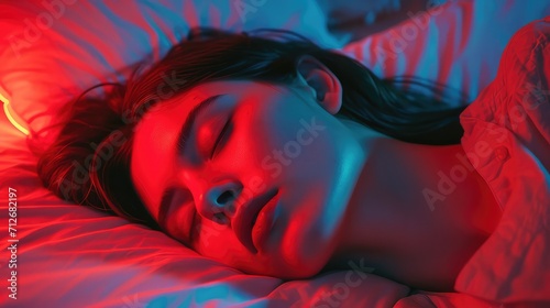 A moment of calm: a young girl sleeping amid the soft glow of red and blue light captures the essence of a peaceful sleep