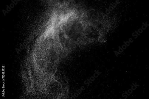 Abstract splashes of water on black background. White explosion. Light overlay texture. 
