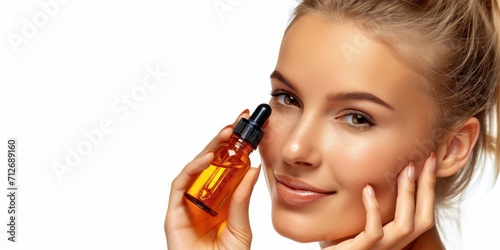 Beautiful smiling young woman with clean skin holding facial essential oil or serum with dropper, rejuvenation and skin care, white background
